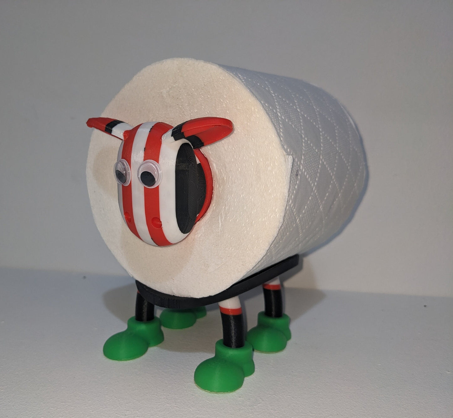 Brentford supporting Premier Sheep spare toilet roll holder with customised choice of the Bees football boots