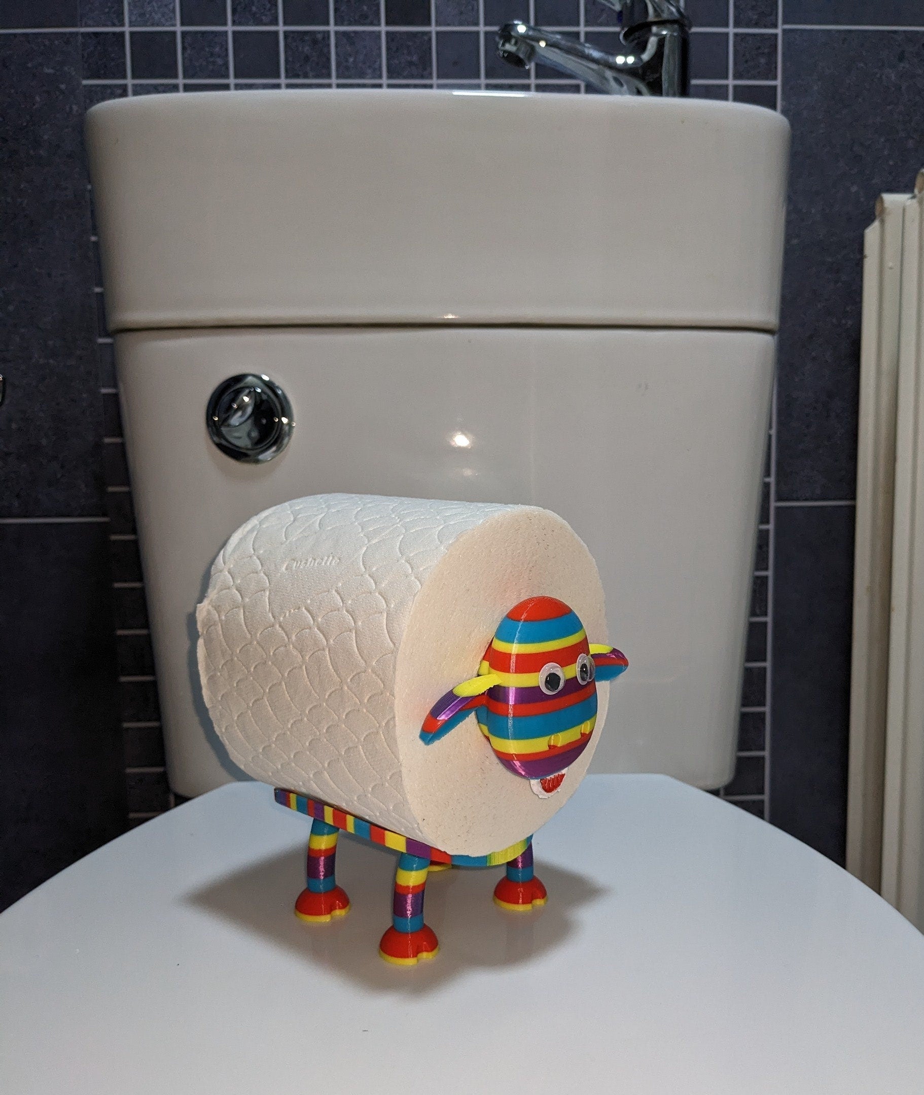 Ewe-Gene the rainbow sheep of the family spare toilet roll holder. The proudest brightest gay LGBTQ+ sheep in the flock.