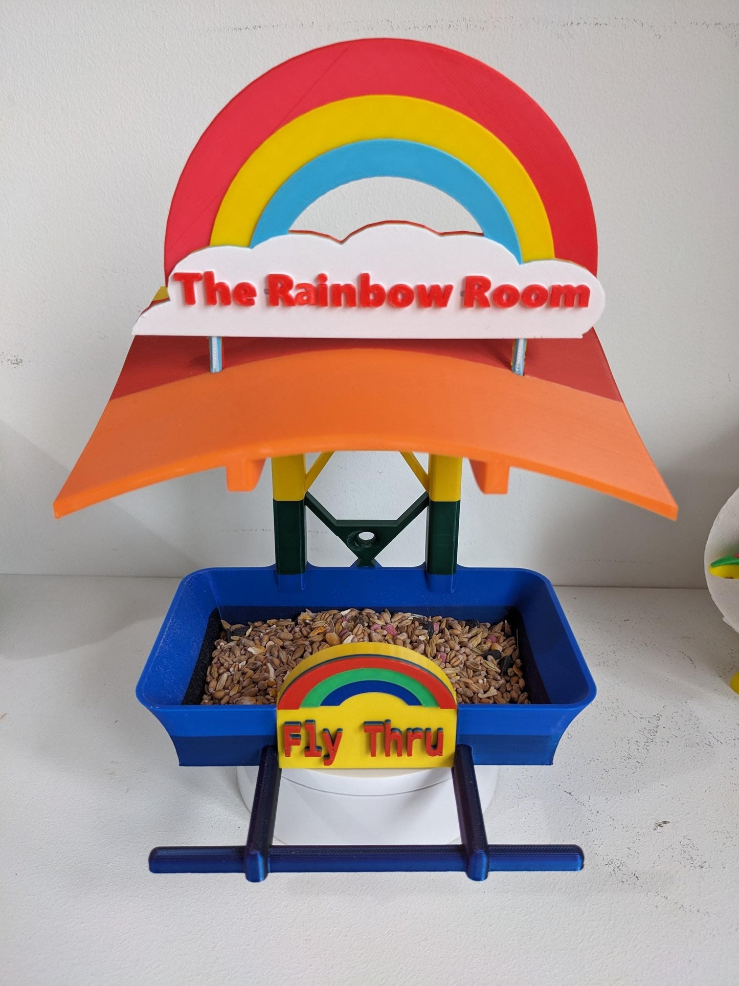 The Rainbow Room 3d printed bird feeding station. The coolest and possibly only LGBTQIA+ rainbow themed bird food table you will ever see.