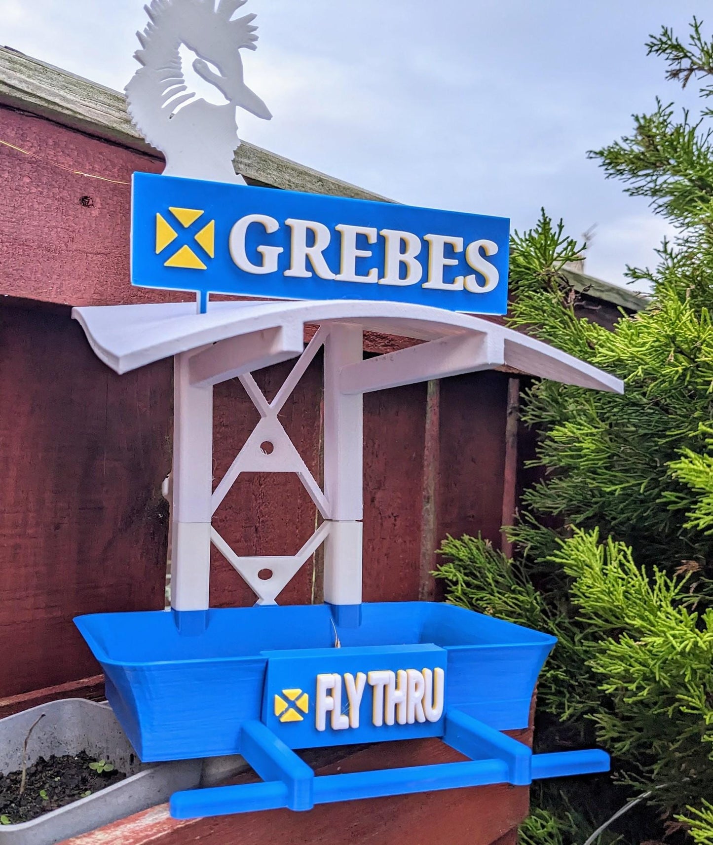 Grebes Fly Thru 3d printed bird feeding station. The coolest feeder table takeaway in town for your feathered friends. Seed, Fat ball