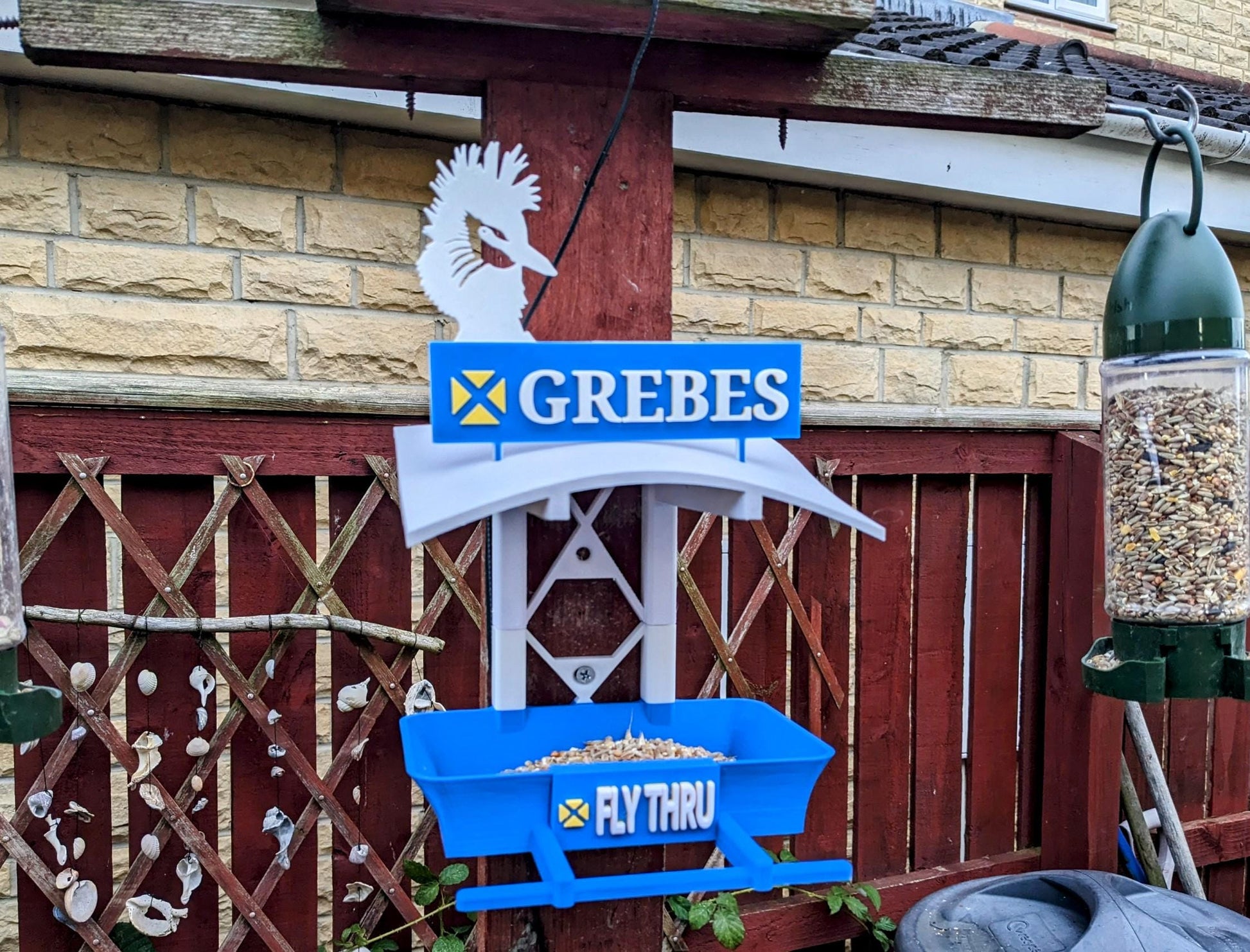 Grebes Fly Thru 3d printed bird feeding station. The coolest feeder table takeaway in town for your feathered friends. Seed, Fat ball