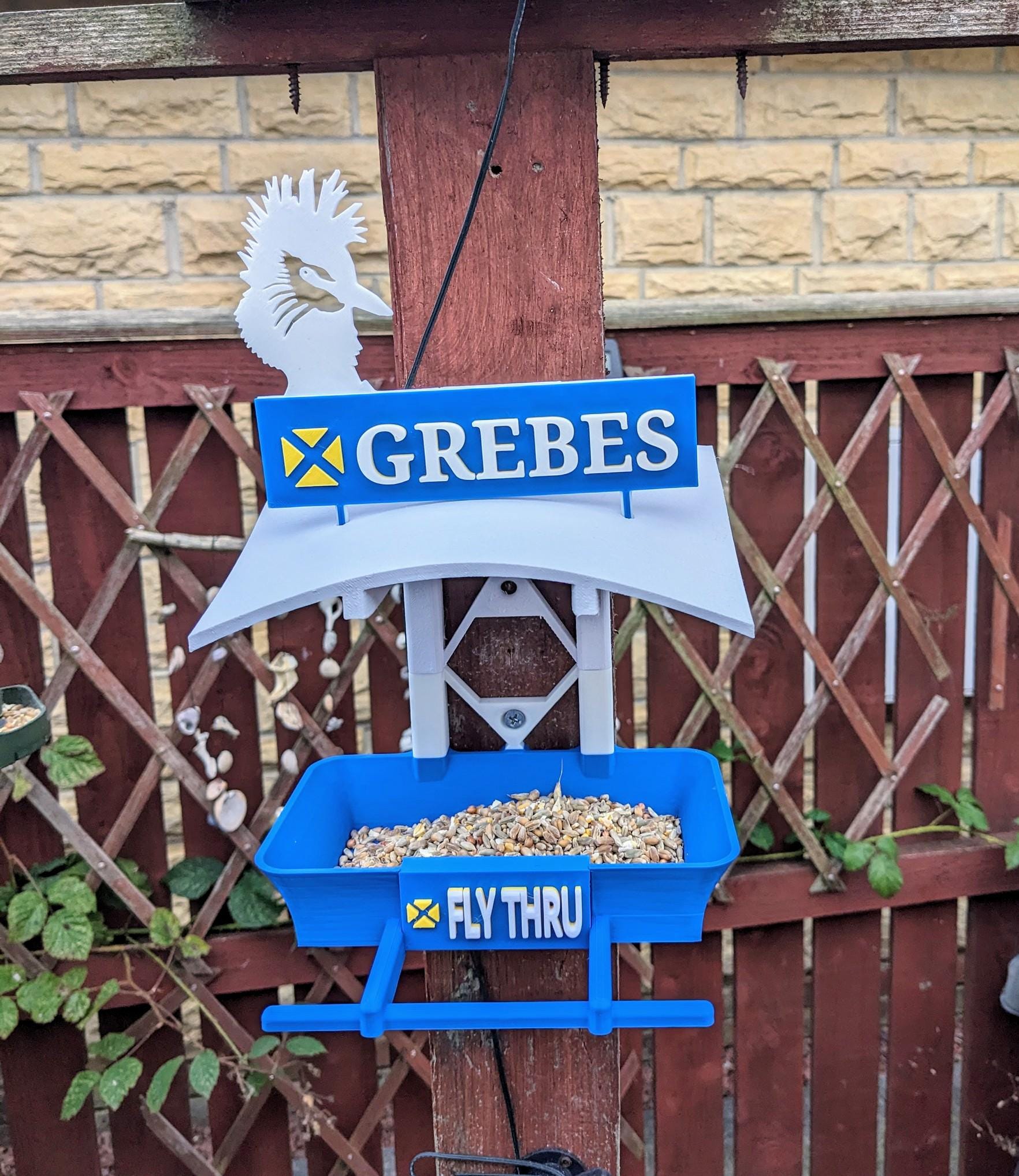 Grebes Fly Thru 3d printed bird feeding station. The coolest feeder table takeaway in town for your feathered friends. Seed, Fat ball